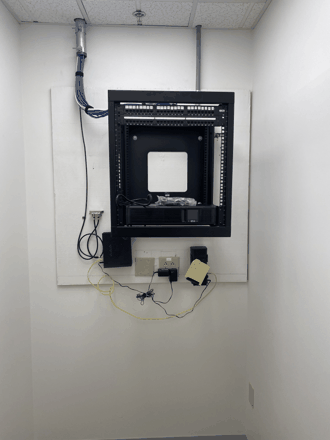Wall-mount network rack, after: dressed, labeled, done.