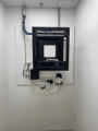 Wall-mount network rack, after: dressed, labeled, done.